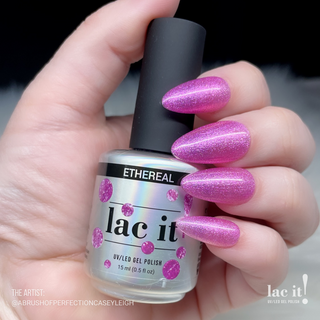 en Vogue Lac It! Ethereal baby pink jelly with gold and pink micro-glitters UV/LED gel nail polish for professional nails and extensions swatcho on long manicured nails holding polish bottle