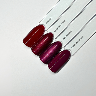 en Vogue Lac it! Enchantress, a sultry plum-red pearl UV/LED gel polish for professional nails and extensions shown on nail swatch sicks with Crimson, 50 Shades on Red and Tempranillo Time